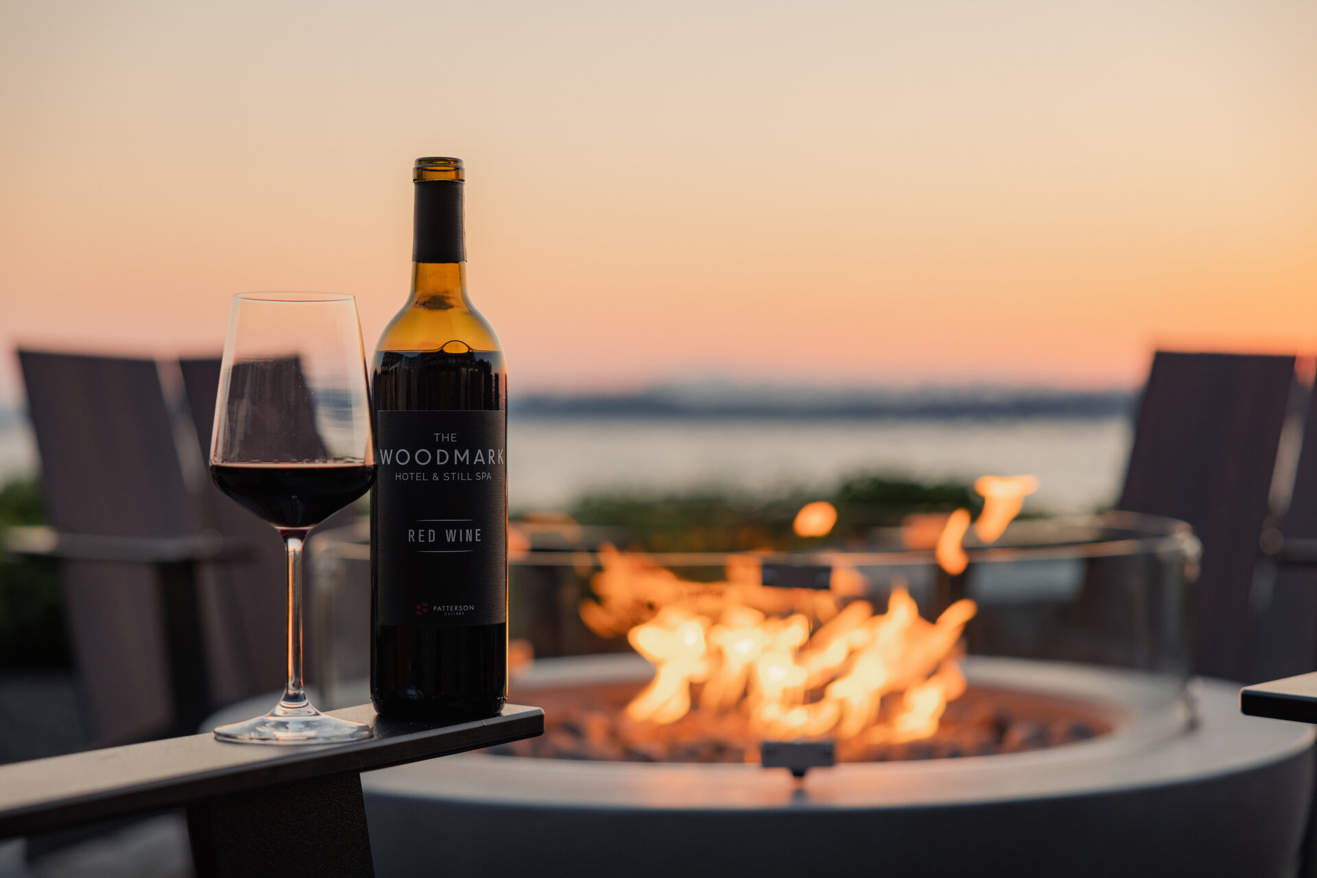 wine bottle sitting on fireplace overlooking lake washington